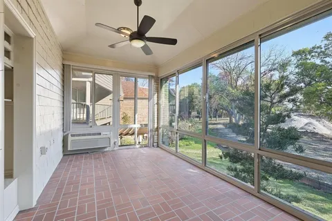 a view of a porch with a floor to ceiling window and yard