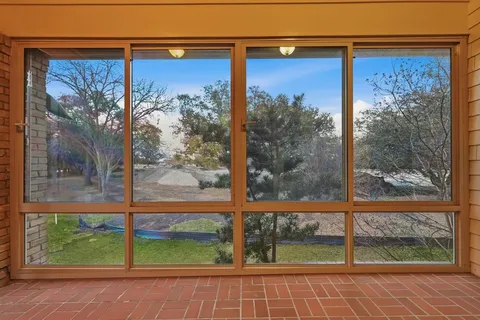 a view of a backyard with wooden fence