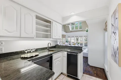 a view of a dining room with furniture wooden floor and a rug