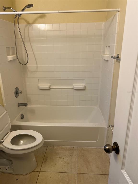 9122 Moonlit Meadows Loop, Unit 1 Riverview, FL 33578 - Photo 9 of 13 a bathroom with a shower a toilet and a shower
