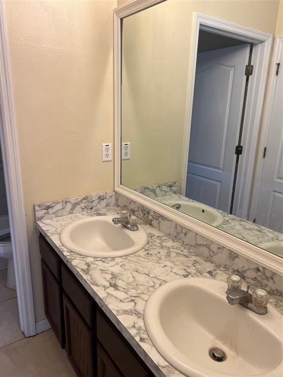 9122 Moonlit Meadows Loop, Unit 1 Riverview, FL 33578 - Photo 10 of 13 a bathroom with a granite countertop sink and a mirror
