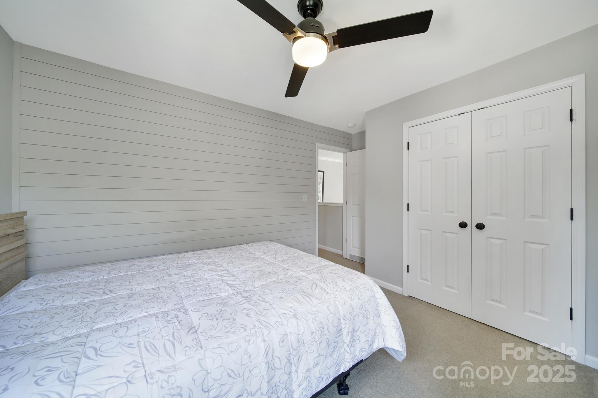 5515 Alexandrite Way Fort Mill, SC 29708 - Photo 26 of 48 a bedroom with a bed and a chandelier fan