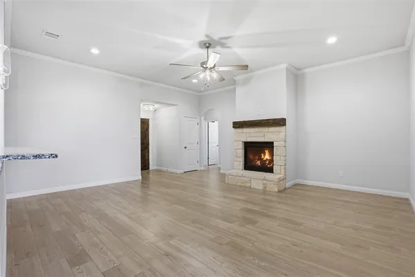 an empty room with fan and windows