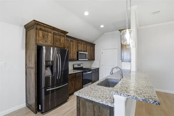 a kitchen with refrigerator and tub