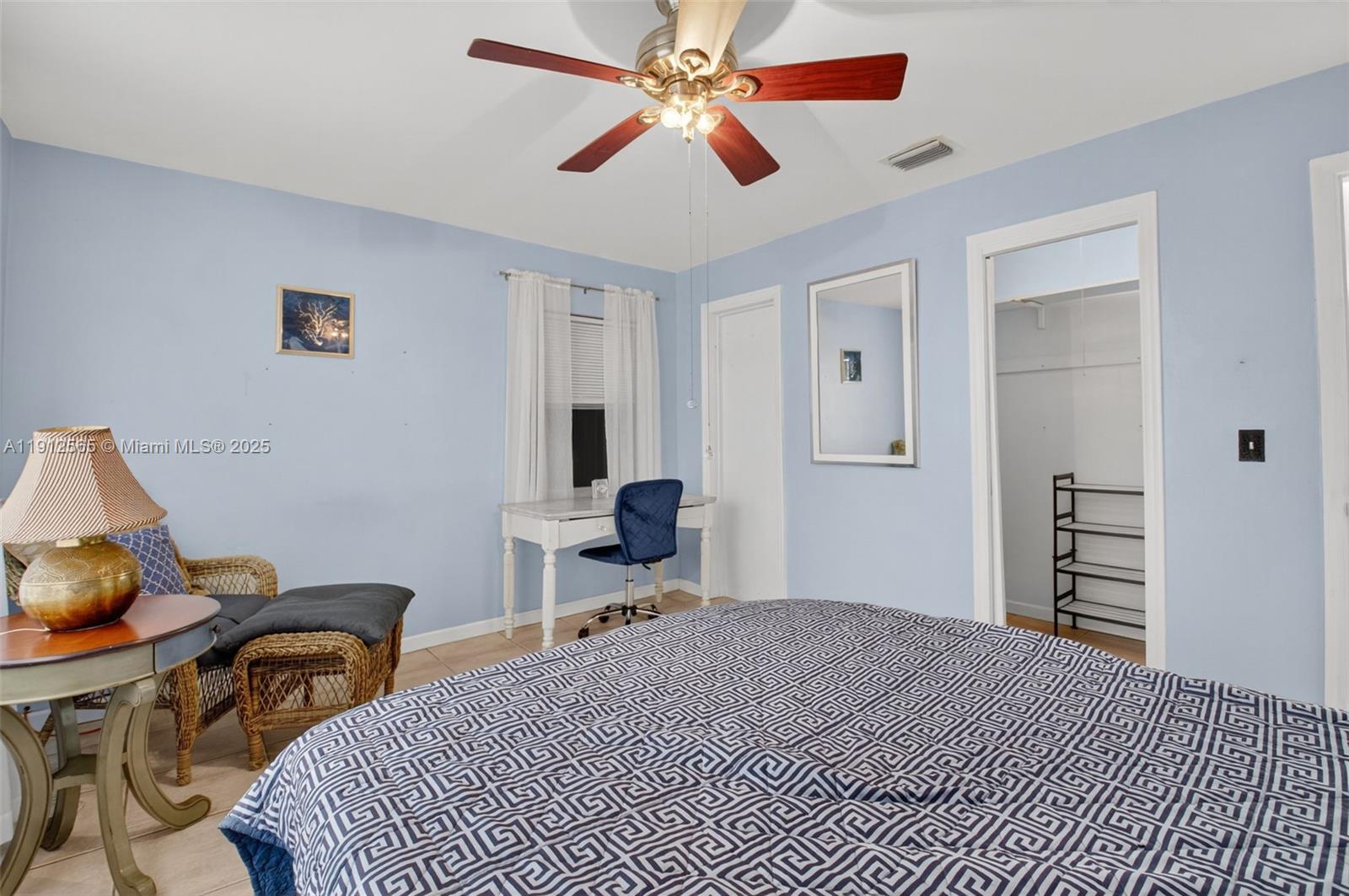 5172 Pine Tree Drive Delray Beach, FL 33484 - Photo 20 of 59 a bedroom with a bed and a chandelier