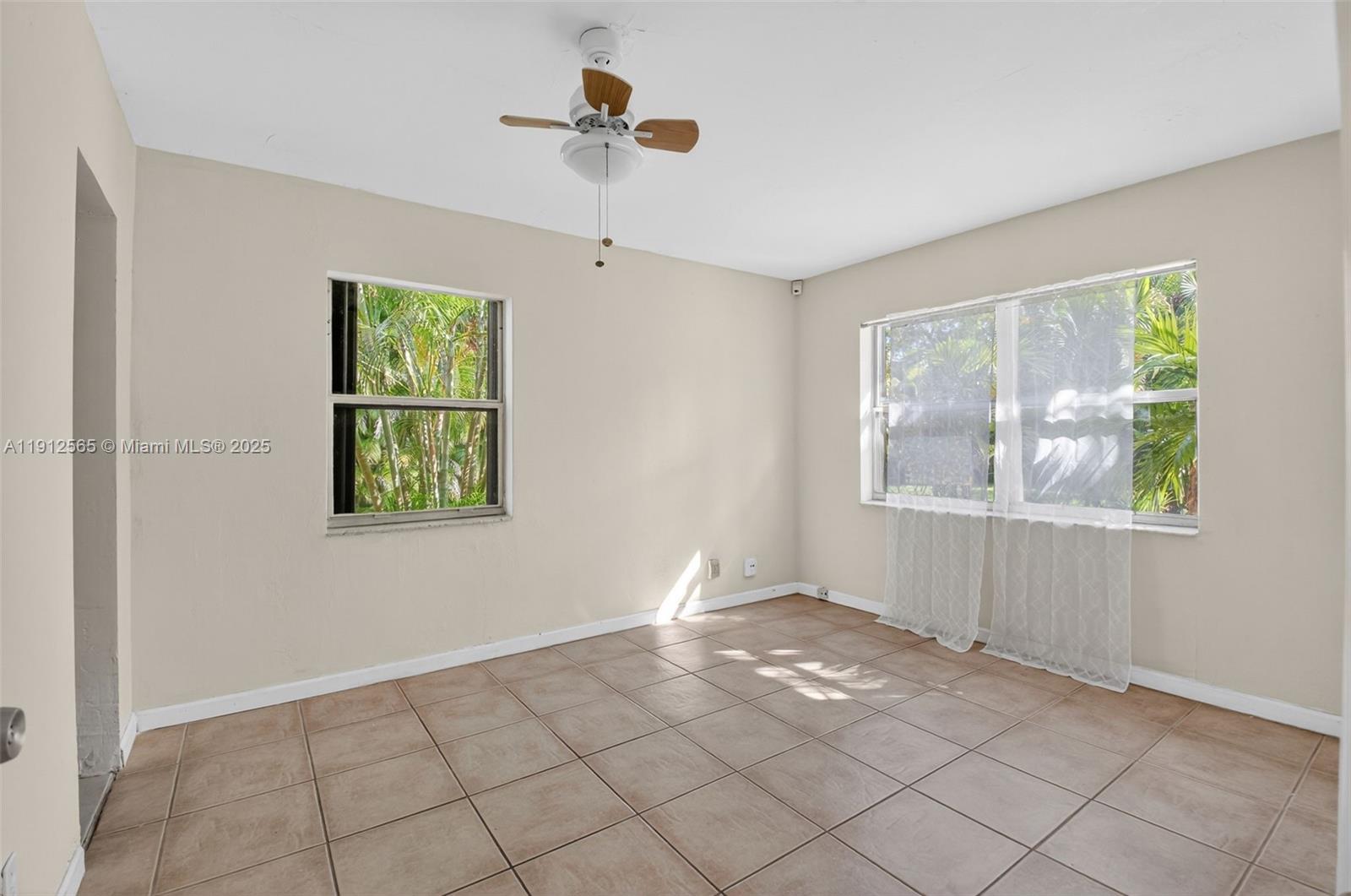 5172 Pine Tree Drive Delray Beach, FL 33484 - Photo 21 of 59 a view of an empty room with window and cabinet