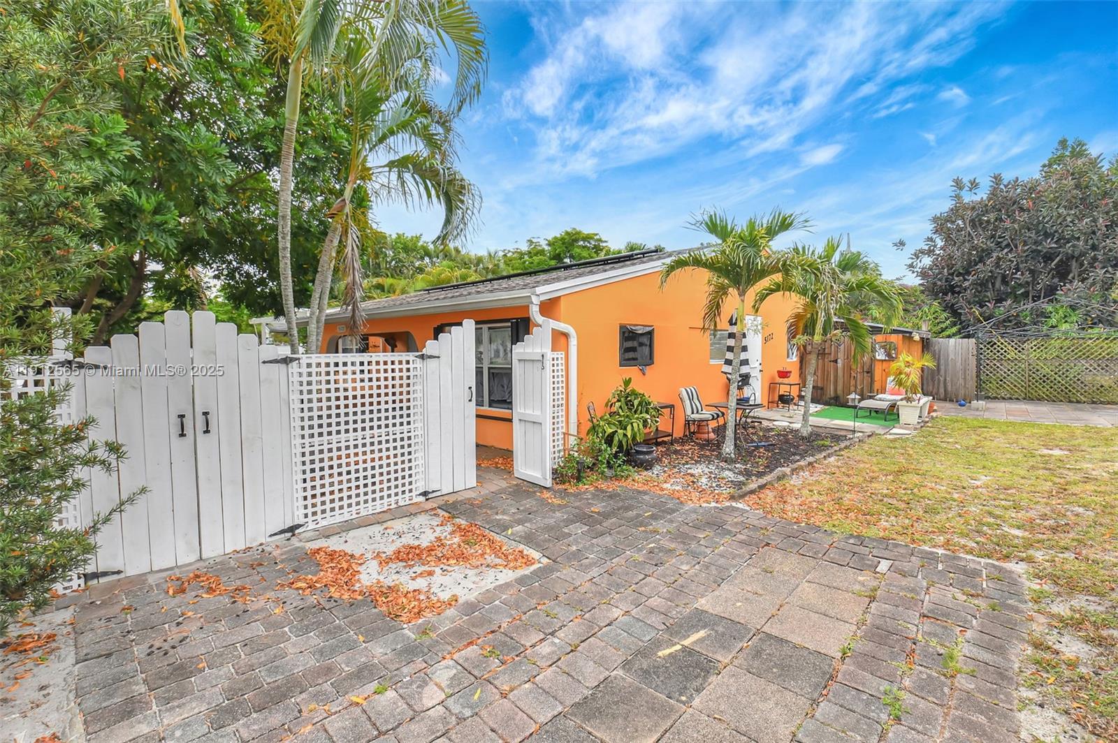 5172 Pine Tree Drive Delray Beach, FL 33484 - Photo 27 of 59 a backyard of a house with table and chairs