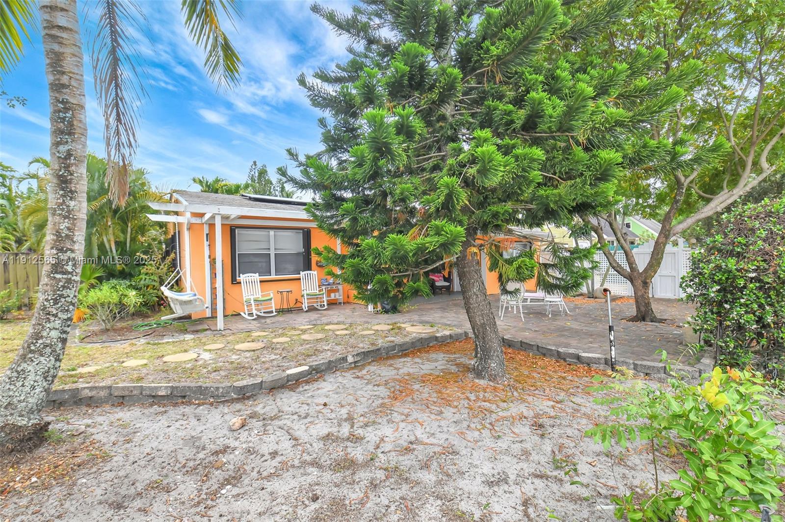 5172 Pine Tree Drive Delray Beach, FL 33484 - Photo 28 of 59 a view of a house with a tree in the background