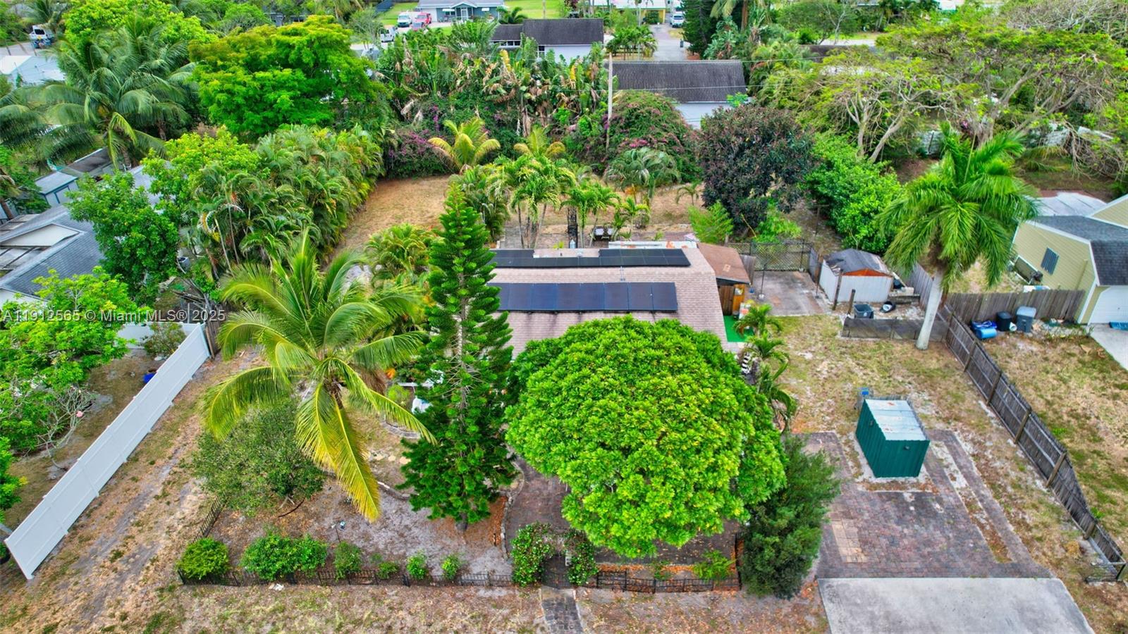 5172 Pine Tree Drive Delray Beach, FL 33484 - Photo 47 of 59 a backyard of a house with lots of green space