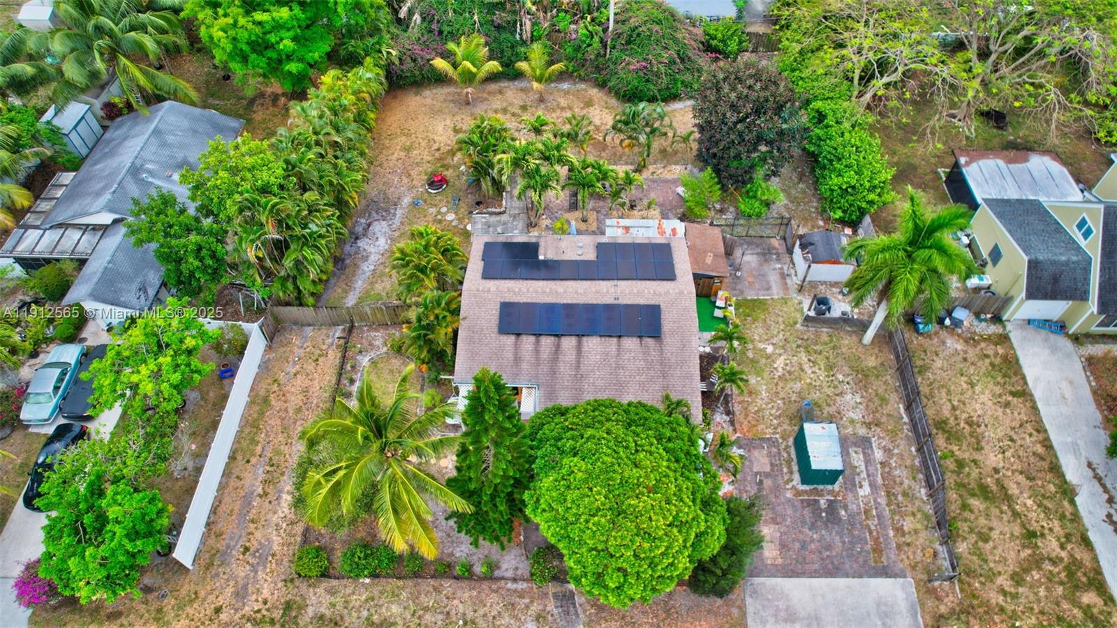 5172 Pine Tree Drive Delray Beach, FL 33484 - Photo 48 of 59 an aerial view of a house with a yard and garden