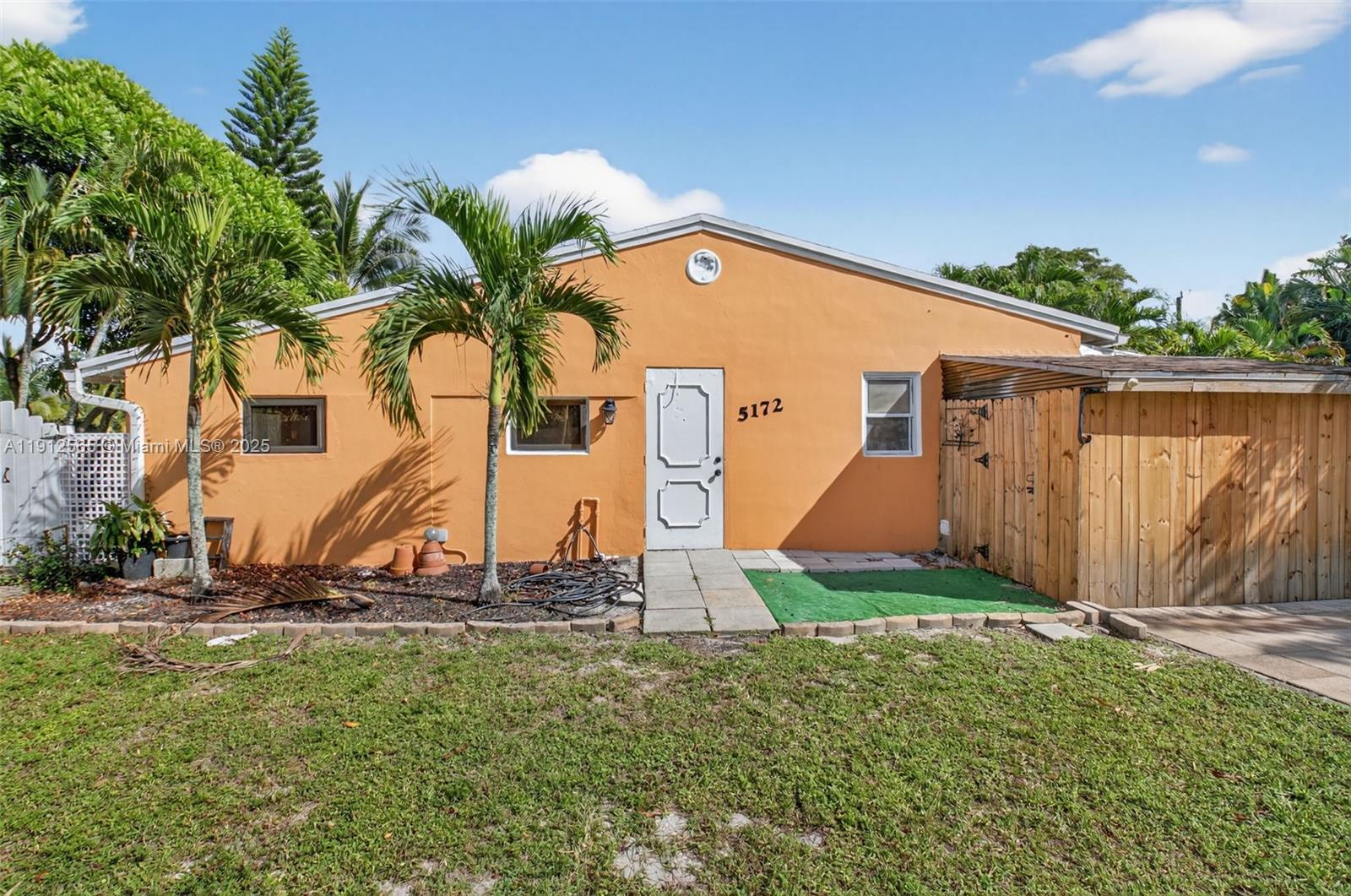 5172 Pine Tree Drive Delray Beach, FL 33484 - Photo 5 of 59 a view of a backyard with potted plants