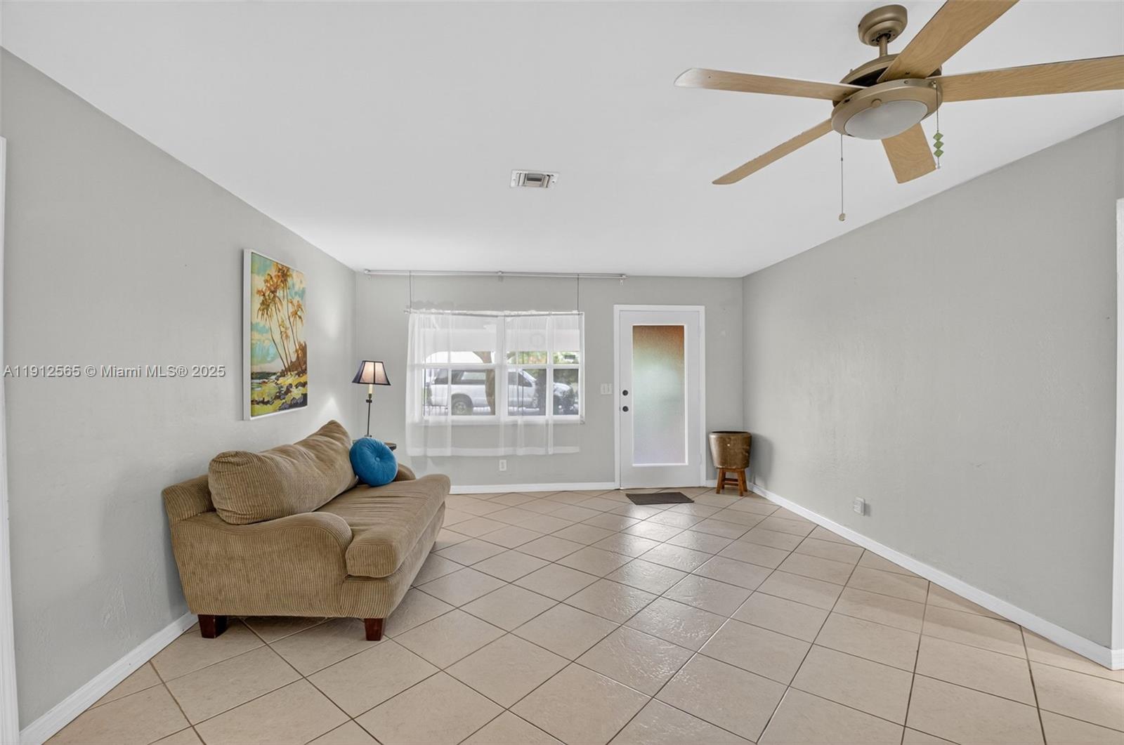 5172 Pine Tree Drive Delray Beach, FL 33484 - Photo 7 of 59 a living room with furniture and a window