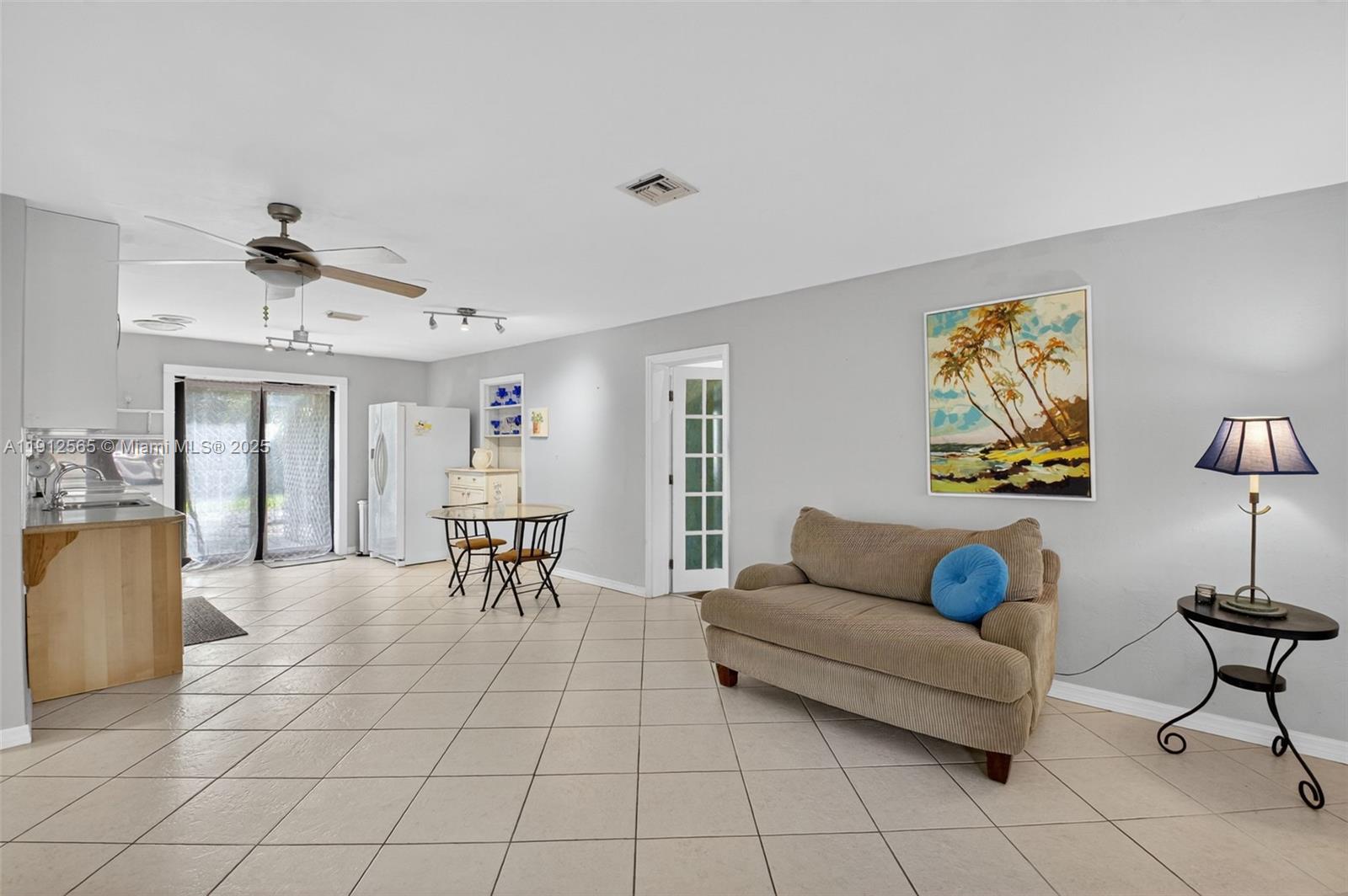 5172 Pine Tree Drive Delray Beach, FL 33484 - Photo 8 of 59 a living room with furniture and a dining table with wooden floor