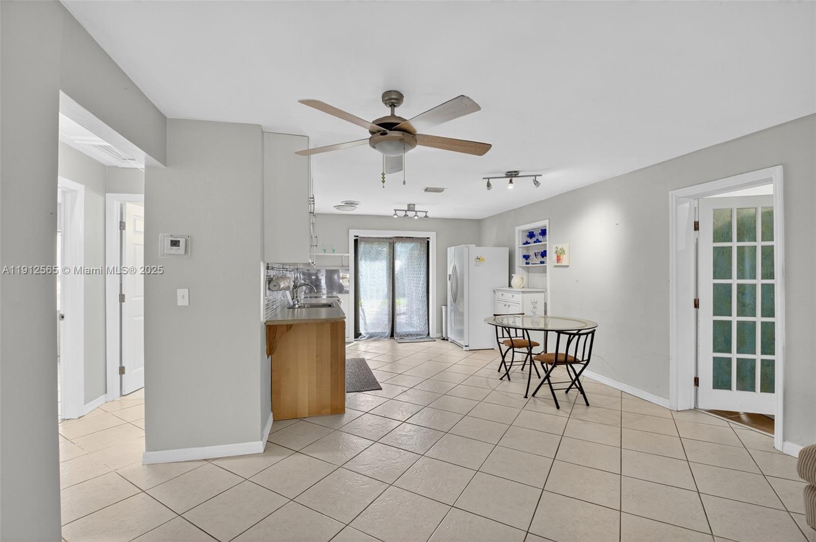 5172 Pine Tree Drive Delray Beach, FL 33484 - Photo 9 of 59 a view of a dining room with furniture and a chandelier