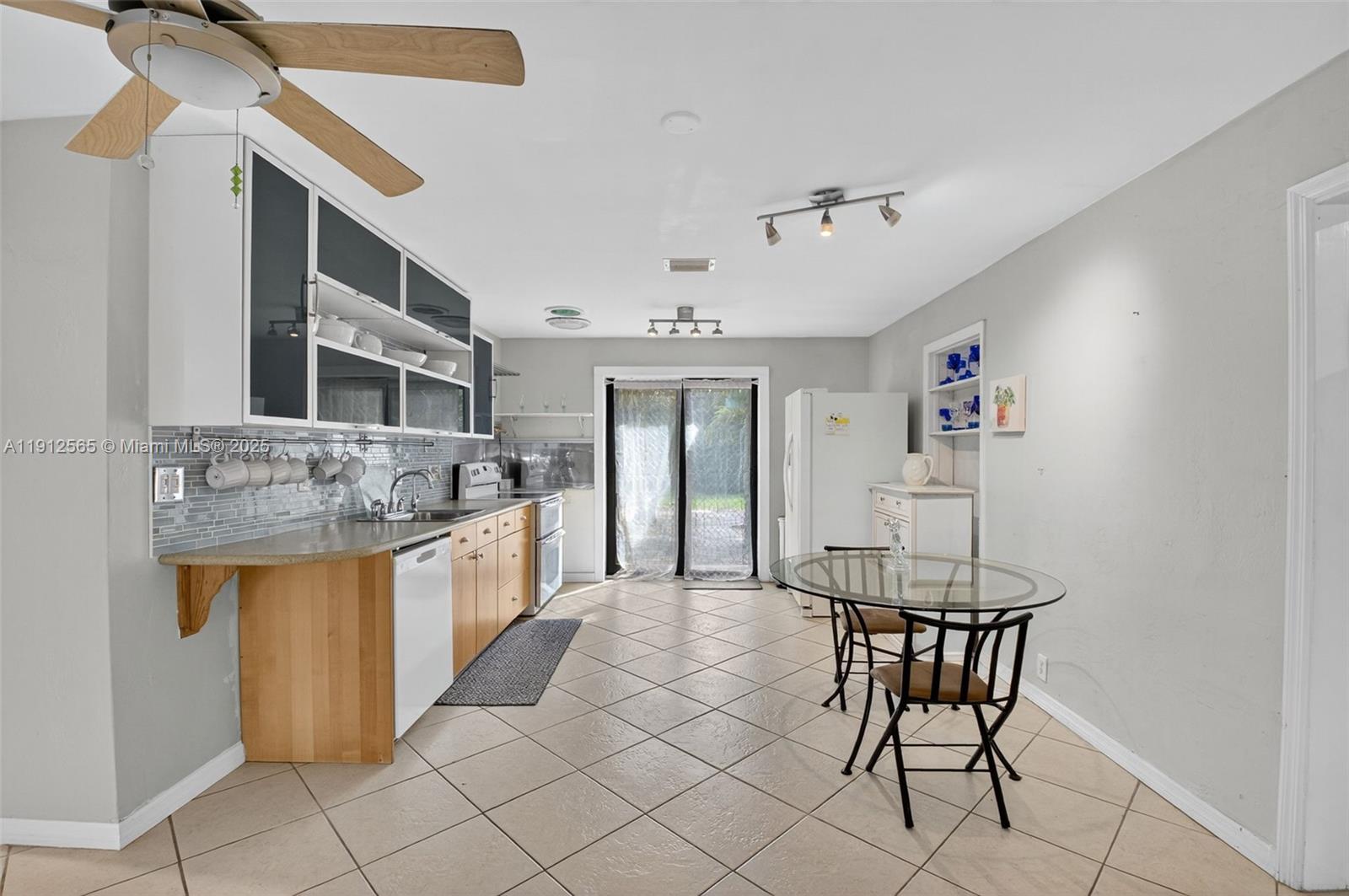 5172 Pine Tree Drive Delray Beach, FL 33484 - Photo 10 of 59 a kitchen with stainless steel appliances kitchen island granite countertop a sink and cabinets