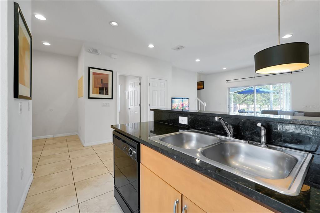 3011 Red Ginger Road Kissimmee, FL 34747 - Photo 12 of 62 a kitchen with a sink a counter top space and a view of living room