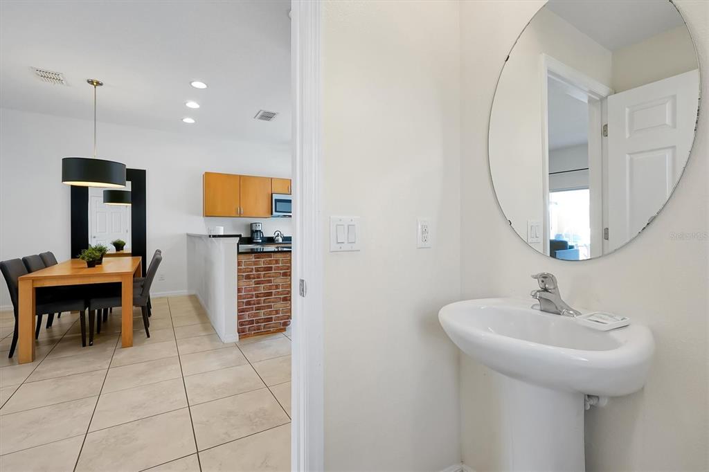 3011 Red Ginger Road Kissimmee, FL 34747 - Photo 15 of 62 a bathroom with a sink a mirror and a potted plant