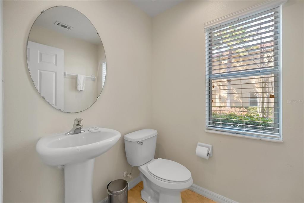 3011 Red Ginger Road Kissimmee, FL 34747 - Photo 16 of 62 a bathroom with a toilet a sink and a mirror