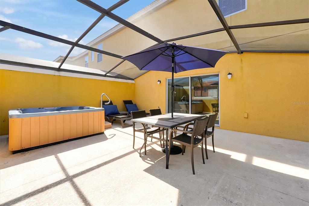 3011 Red Ginger Road Kissimmee, FL 34747 - Photo 18 of 62 a view of a patio with table and chairs under an umbrella