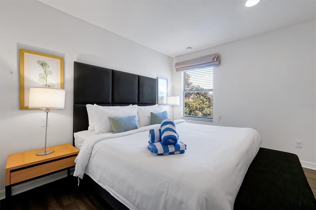 3011 Red Ginger Road Kissimmee, FL 34747 - Photo 22 of 62 a bedroom with a bed and wooden floor