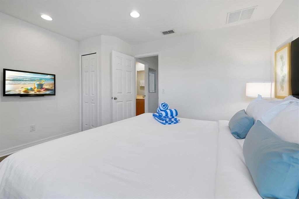 3011 Red Ginger Road Kissimmee, FL 34747 - Photo 24 of 62 a bedroom with a bed and a painting on the wall