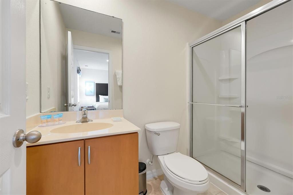 3011 Red Ginger Road Kissimmee, FL 34747 - Photo 25 of 62 a bathroom with a toilet a sink and a mirror