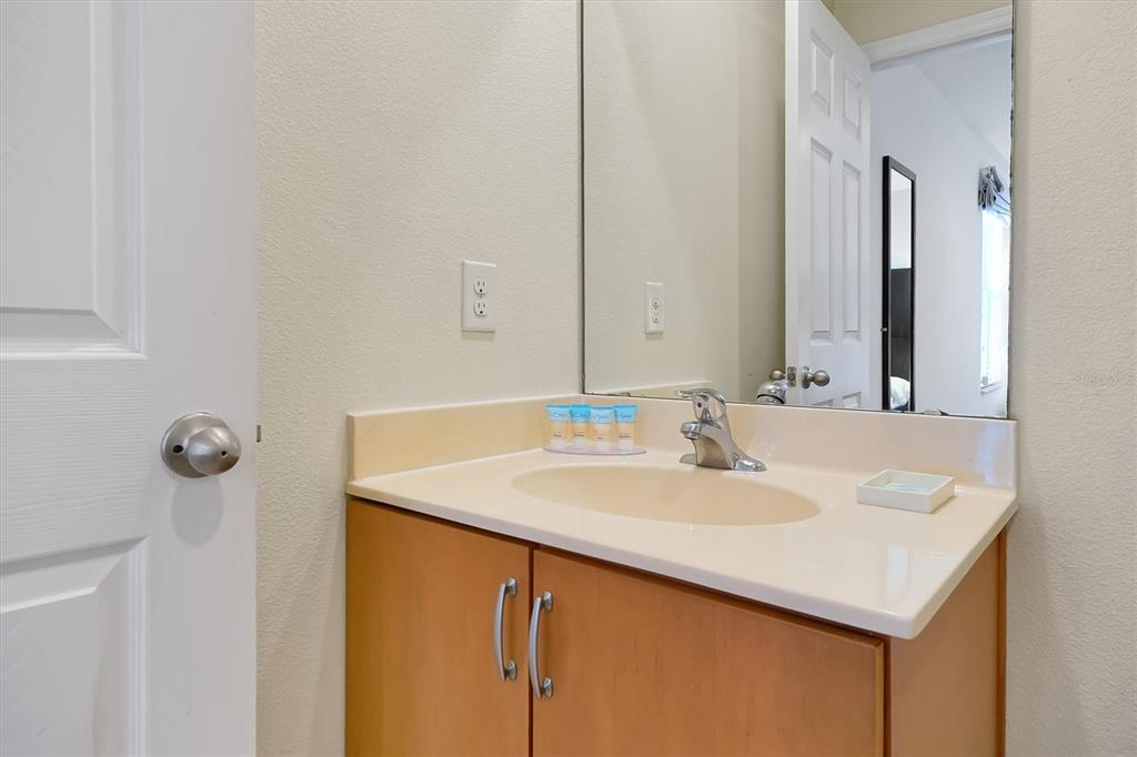 3011 Red Ginger Road Kissimmee, FL 34747 - Photo 26 of 62 a bathroom with a sink and a mirror