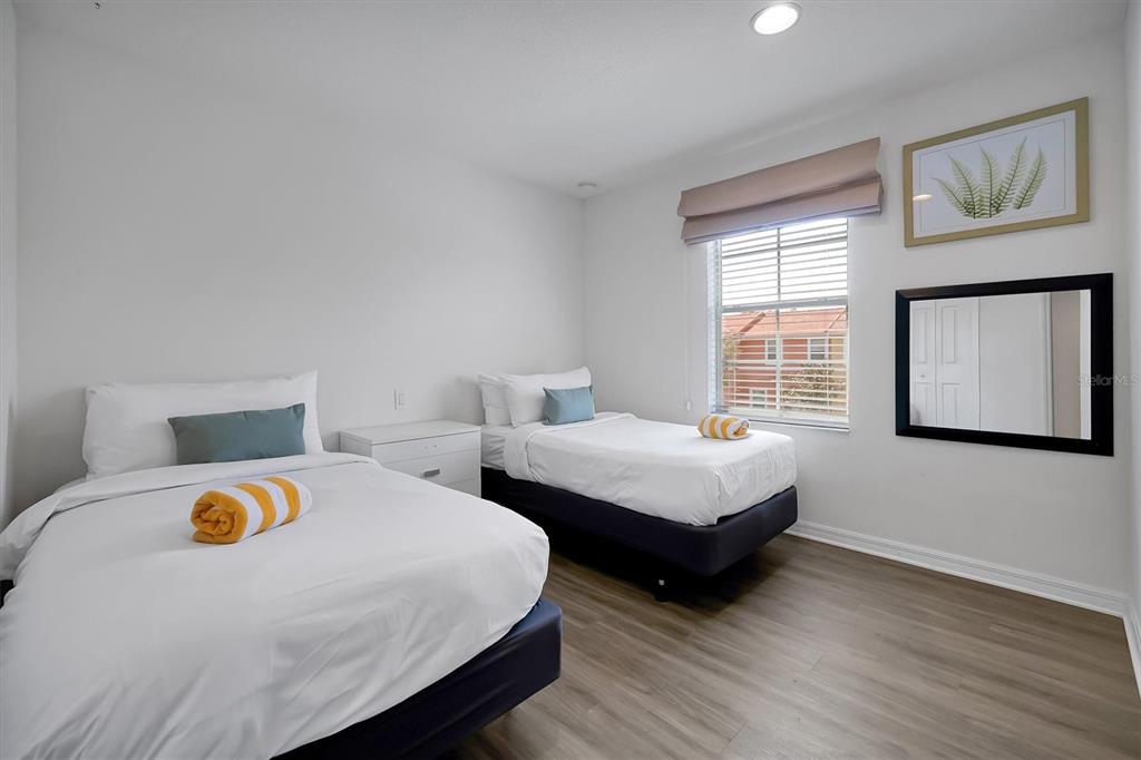 3011 Red Ginger Road Kissimmee, FL 34747 - Photo 28 of 62 a bedroom with two beds and wooden floor