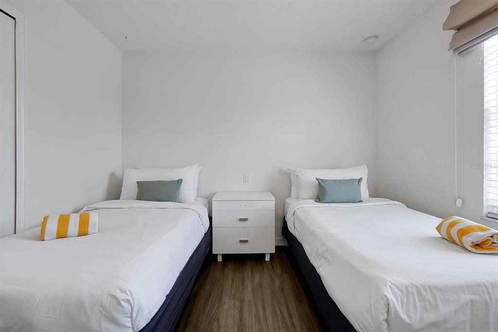 3011 Red Ginger Road Kissimmee, FL 34747 - Photo 29 of 62 a bedroom with a bed and a table