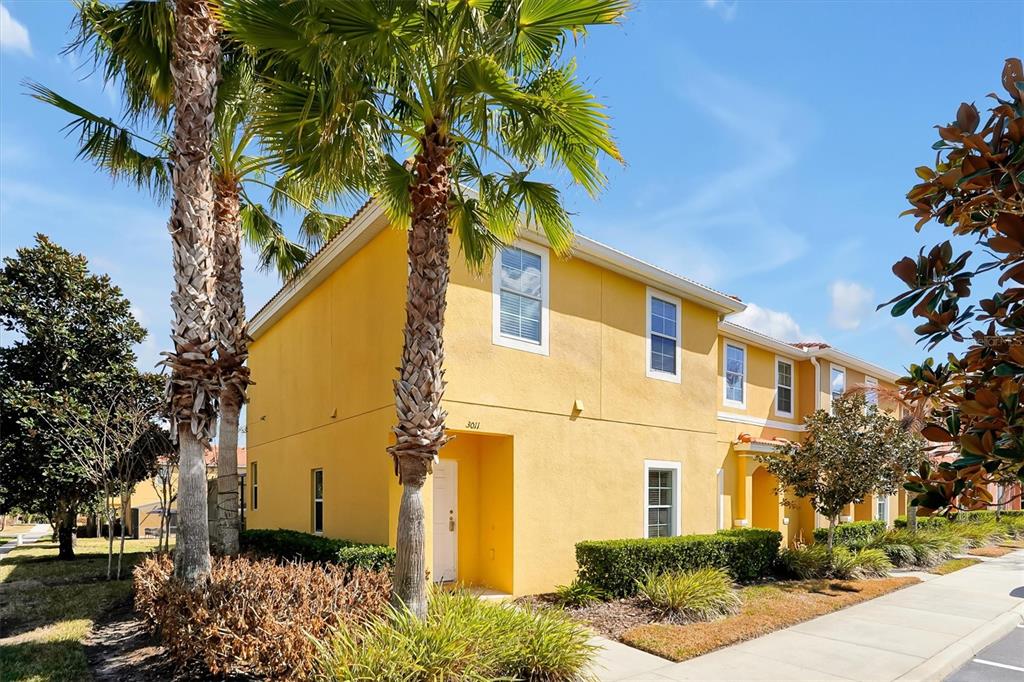 3011 Red Ginger Road Kissimmee, FL 34747 - Photo 3 of 62 a yellow house with trees in front of it