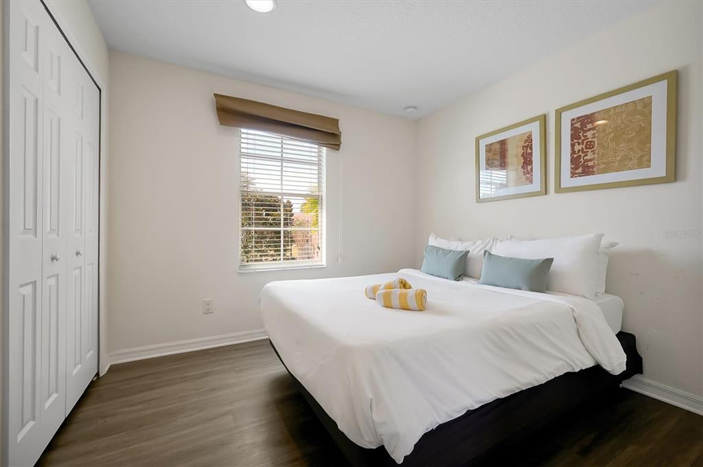 3011 Red Ginger Road Kissimmee, FL 34747 - Photo 32 of 62 a bedroom with a bed and wooden floor