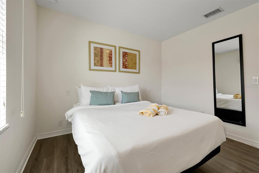 3011 Red Ginger Road Kissimmee, FL 34747 - Photo 33 of 62 a bedroom with a bed and a night stand