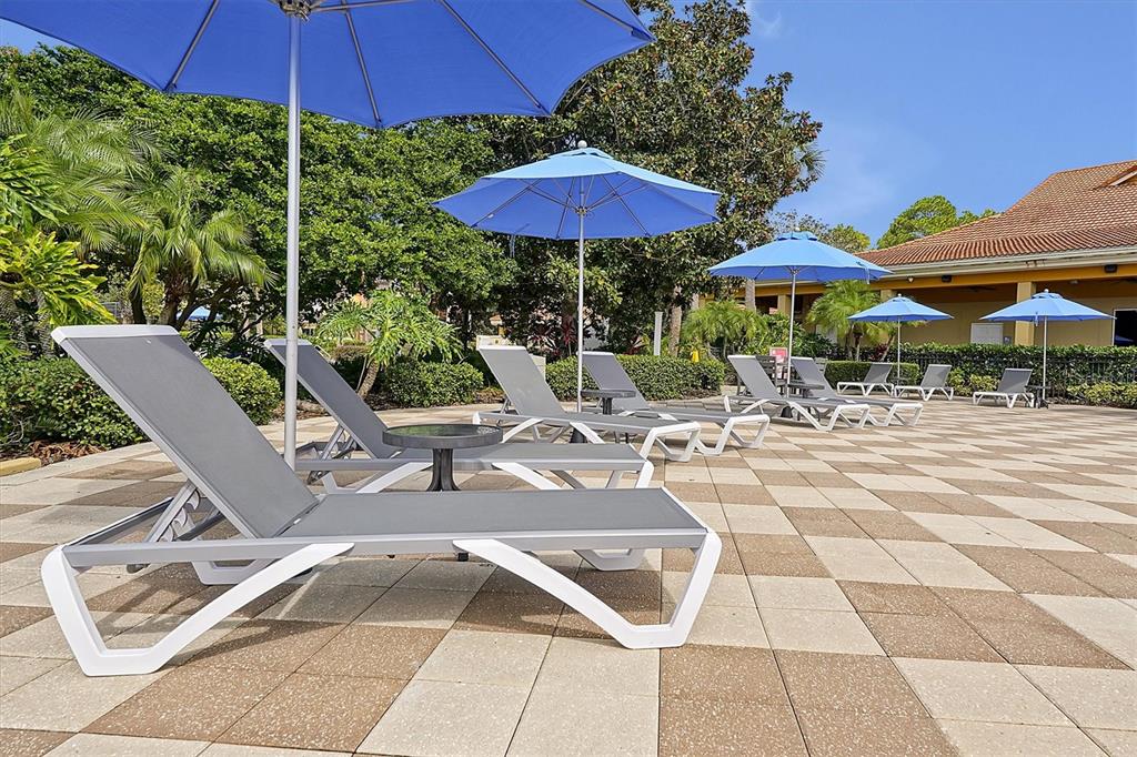 3011 Red Ginger Road Kissimmee, FL 34747 - Photo 46 of 62 a view of patio with chairs and table under an umbrella
