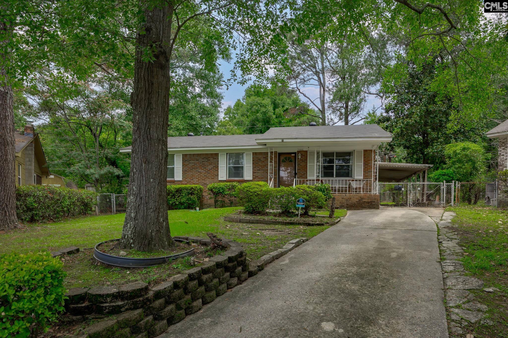 5666 Middleton Court Columbia, SC 29203 - Photo 4 of 42 a front view of a house with a yard and green space