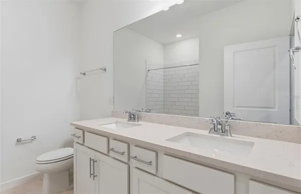a bathroom with a sink toilet and vanity