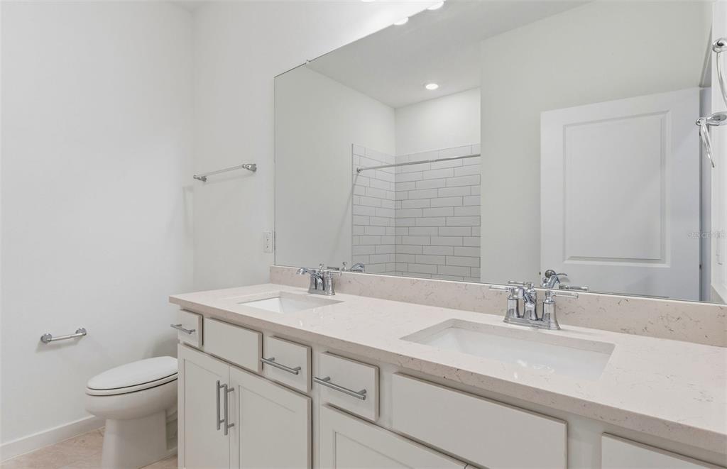 3734 Obsidian Drive Spring Hill, FL 34609 - Photo 13 of 25 a bathroom with a sink toilet and vanity