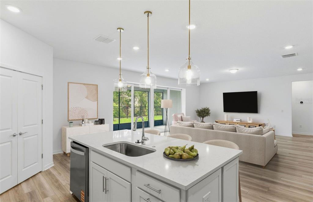 3734 Obsidian Drive Spring Hill, FL 34609 - Photo 2 of 25 a kitchen with a sink a counter top space and living room view