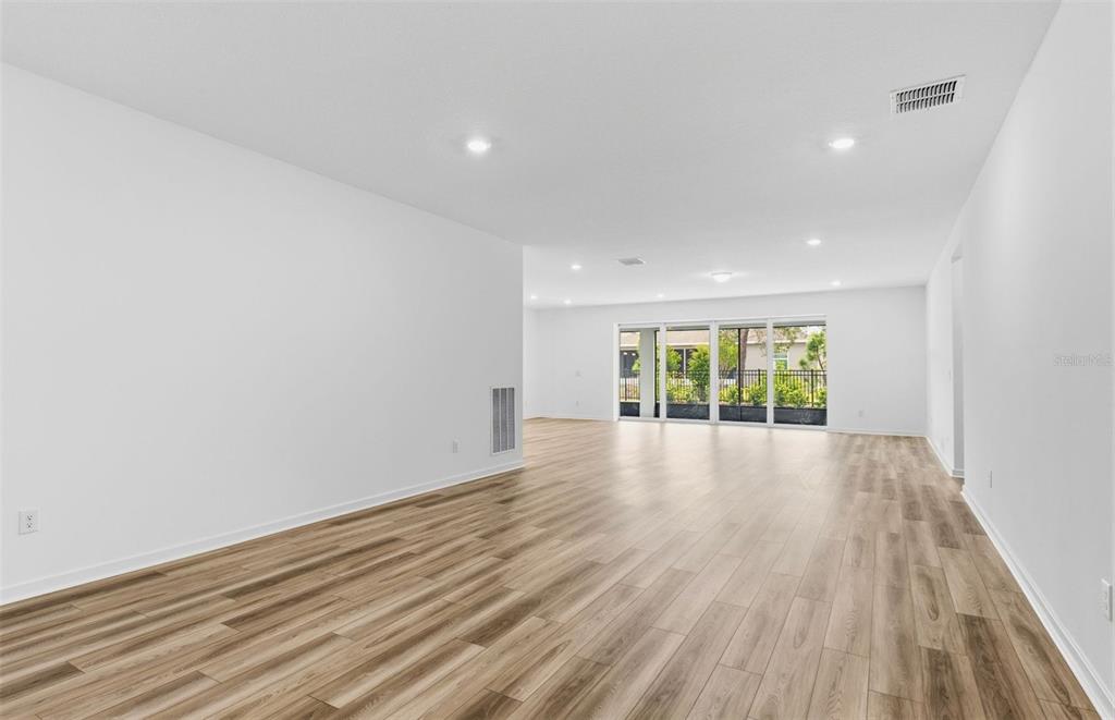 3734 Obsidian Drive Spring Hill, FL 34609 - Photo 7 of 25 a view of an empty room with wooden floor and a window