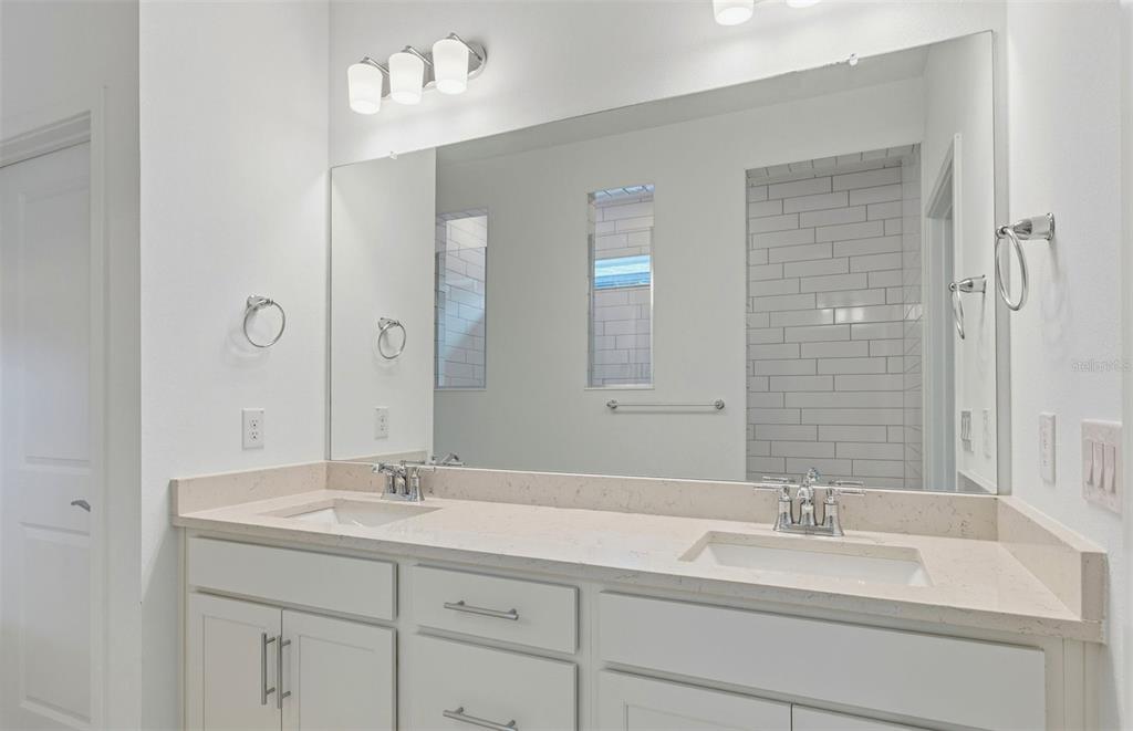 3734 Obsidian Drive Spring Hill, FL 34609 - Photo 9 of 25 a bathroom with a sink double vanity and a mirror