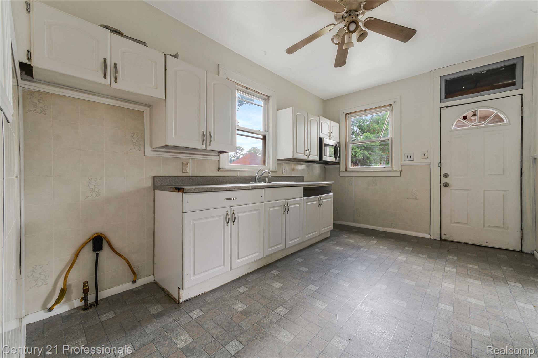 238 Richter Street River Rouge, MI 48218 - Photo 14 of 33 Kitchen featuring white cabinetry, gray countertop, and patterned tile flooring