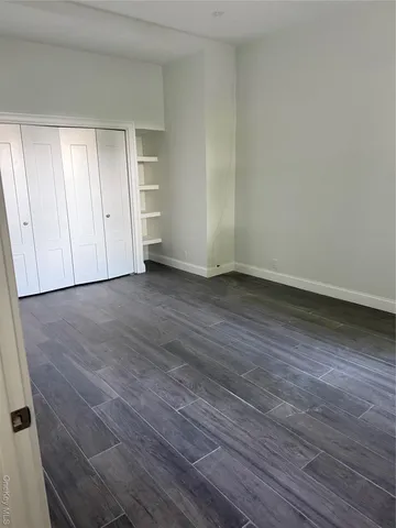 a view of an empty room and wooden floor