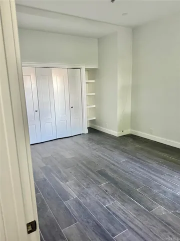a view of an empty room and wooden floor