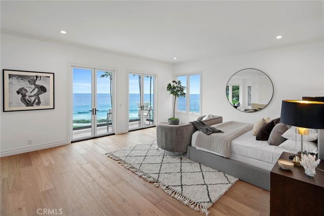 a living room with furniture a table and a large window