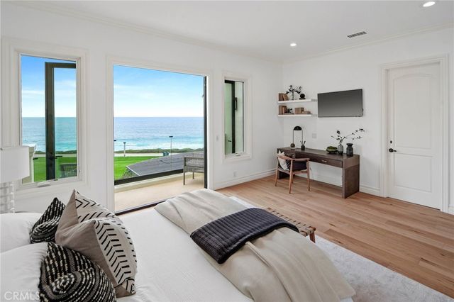 a bedroom with a bed furniture and a flat screen tv