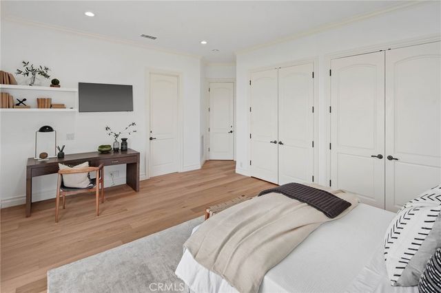 a bedroom with a bed and a flat screen tv