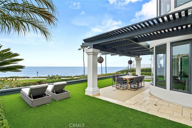 a view of a patio with chairs next to a yard
