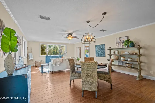 a view of a dining room with furniture window and wooden floor
