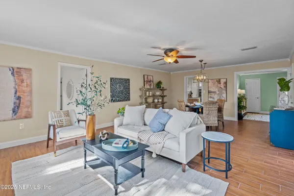 a living room with furniture a wooden floor and a table