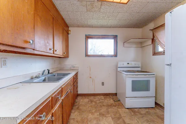 a view of a livingroom with an empty space and a window
