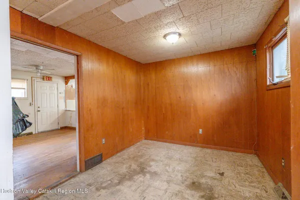a view of a livingroom with wooden floor and a ceiling fan